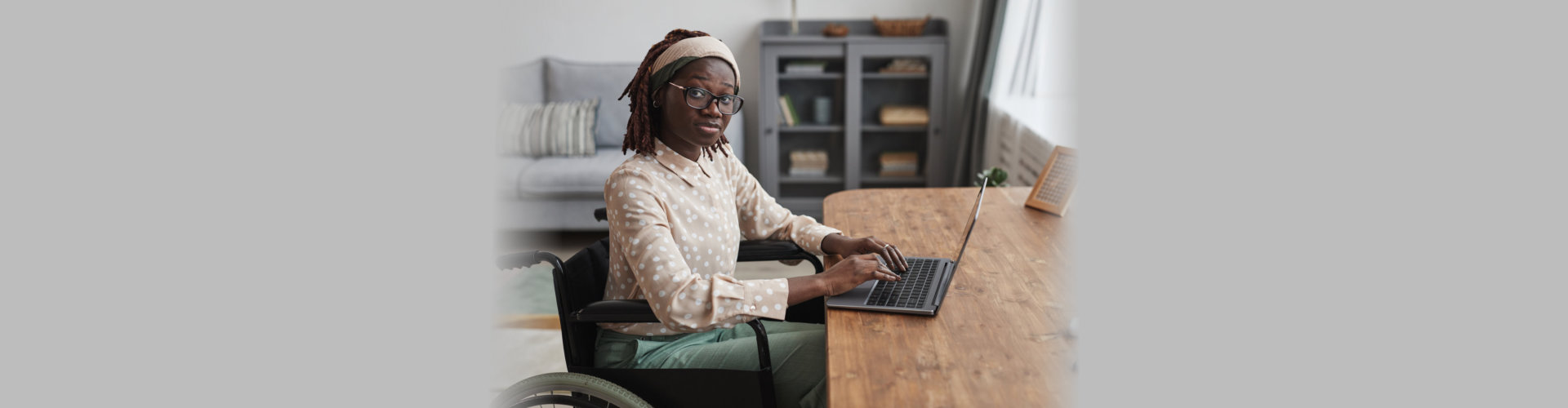 woman on wheelchair using laptop